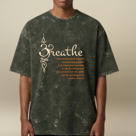 Person wearing a dark green t-shirt with 'Breathe' text design on a beige background