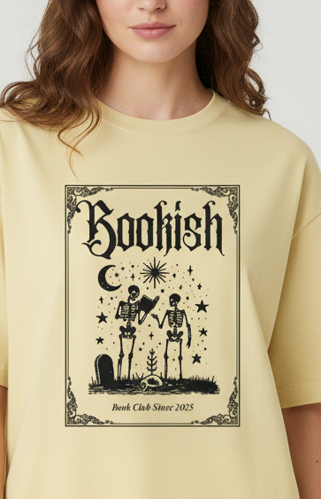 Woman wearing a light yellow t-shirt with a graphic design on a plain background