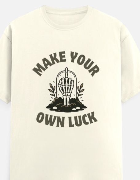 Beige t-shirt with graphic design and text 'Make Your Own Luck' on a white background