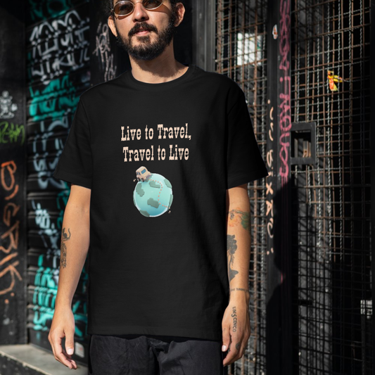 Person wearing a black t-shirt with 'Live to Travel, Travel to Live' design in front of a graffiti-covered wall.