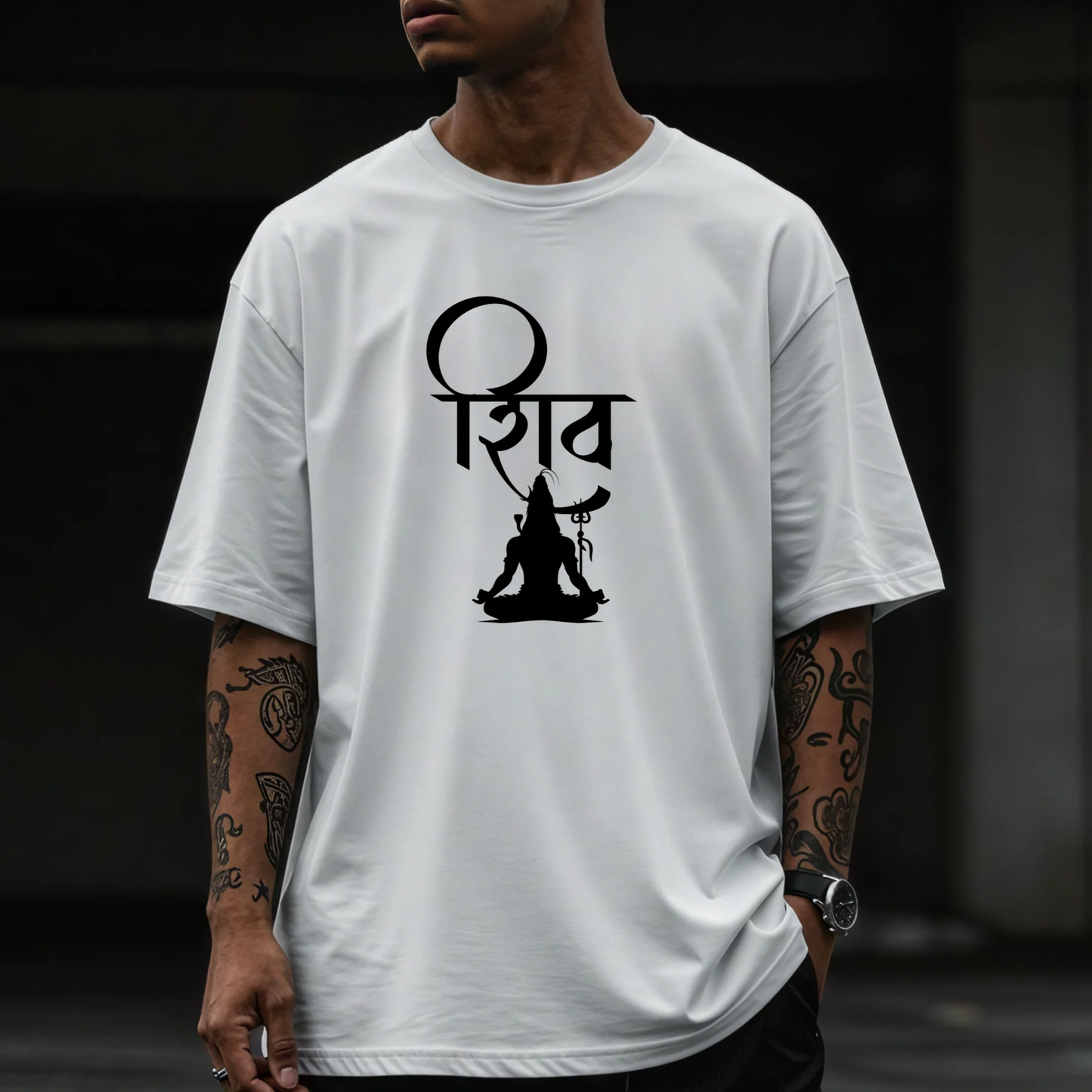 Person wearing a white t-shirt with a black symbol design on a dark background