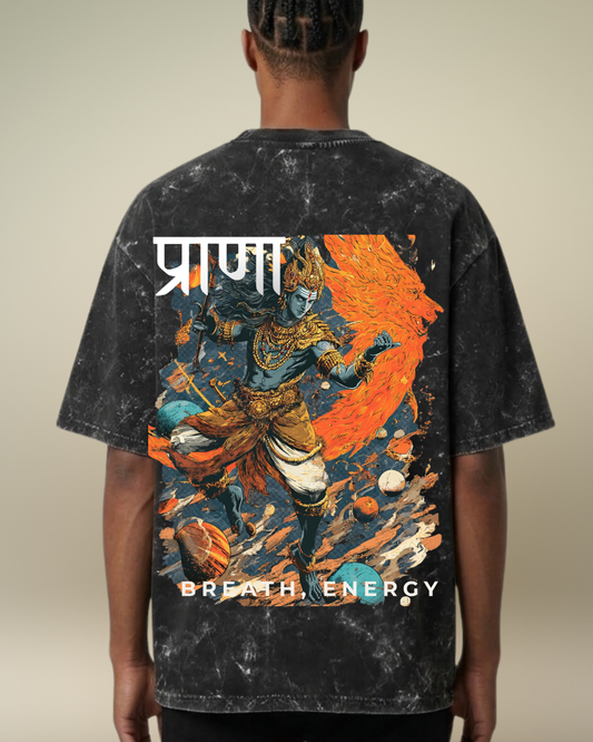 Person wearing a black t-shirt with a colorful graphic design on the back, featuring a character and text.
