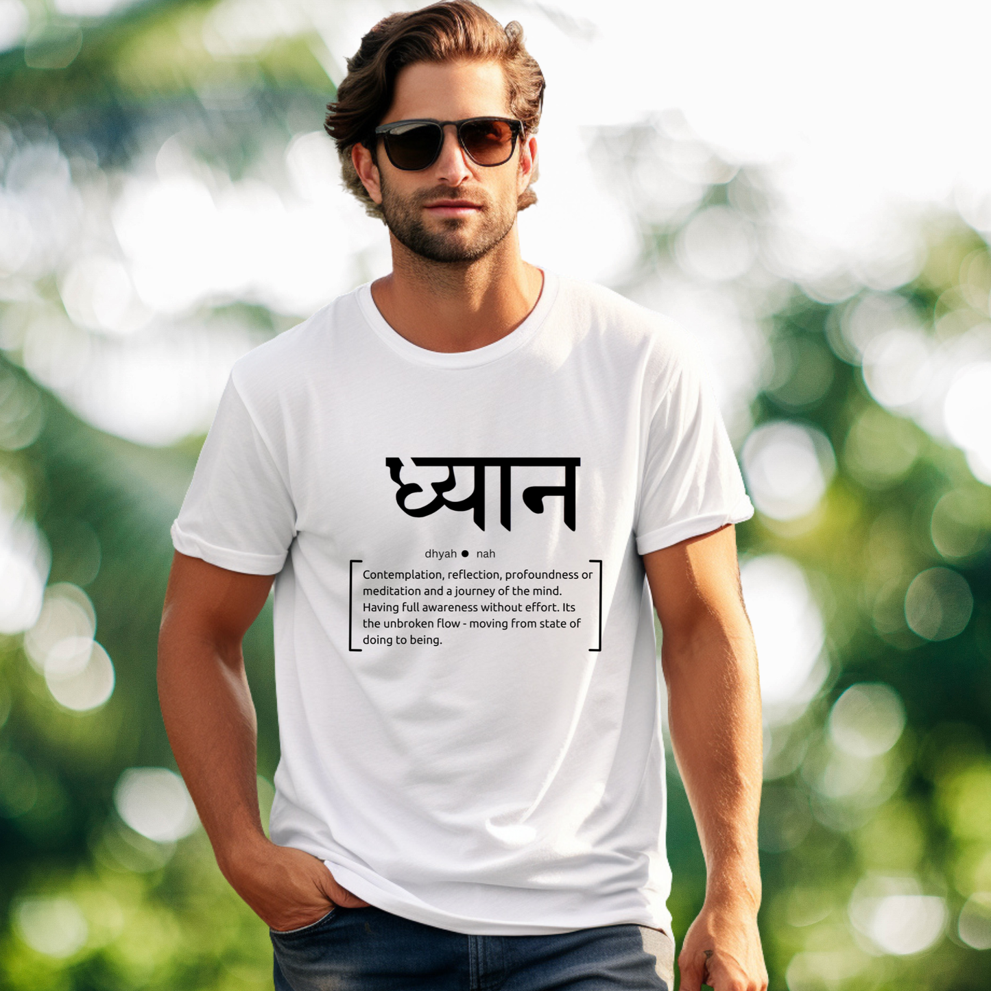 Man wearing a white t-shirt with text in a foreign language against a blurred green background