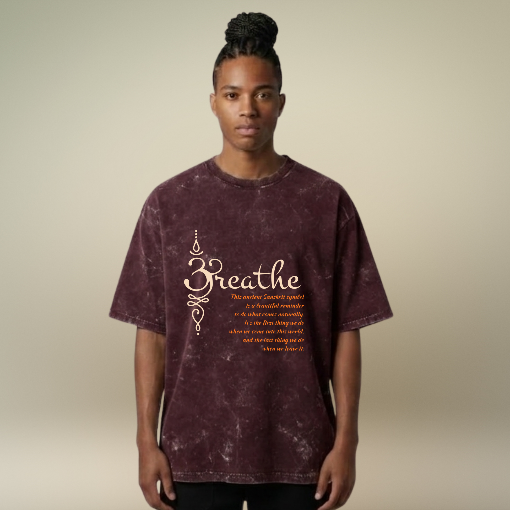 Person wearing a maroon t-shirt with 'Breathe' text on a beige background