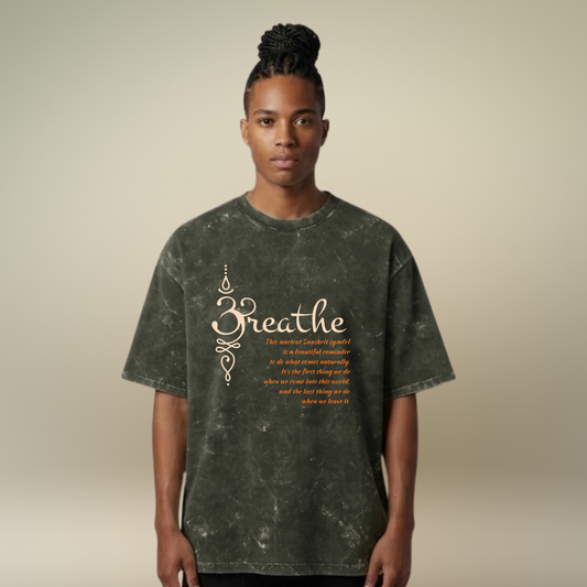 Person wearing a dark green t-shirt with 'Breathe' text on a beige background