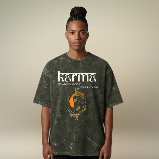 Person wearing a t-shirt with 'karma' and a graphic design on a beige background
