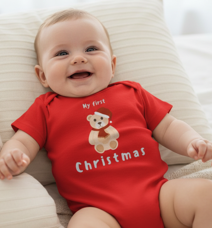 Baby wearing a red 'My first Christmas' onesie with a bear graphic.
