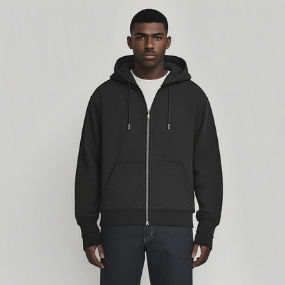 Man wearing a black hoodie and pants on a gray background